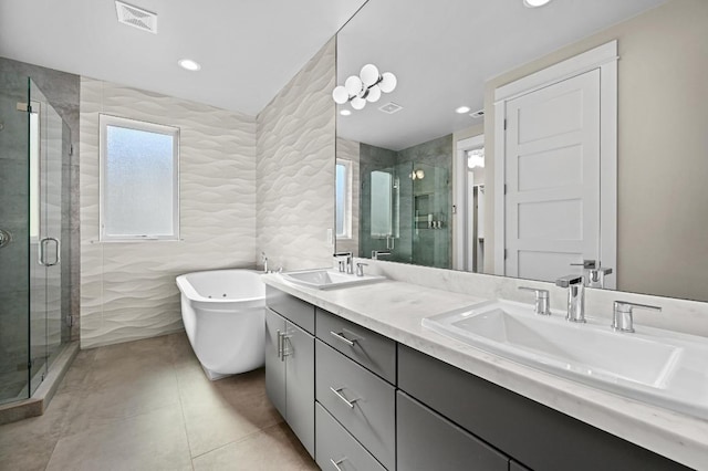 2002 E 8th St, Austin, TX 78702 - bathroom with double vanity, a shower stall, a freestanding bath, tile walls, and tile patterned flooring