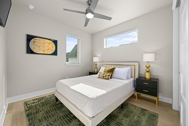 2002 E 8th St, Austin, TX 78702 - bedroom featuring wood finished floors, baseboards, and a ceiling fan