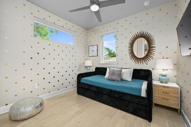 2002 E 8th St, Austin, TX 78702 - bedroom with wallpapered walls, light wood finished floors, multiple windows, and baseboards