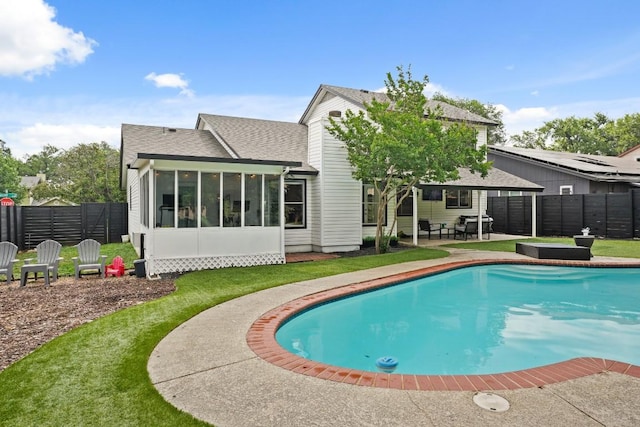 12308 Wycliff Ln, Austin, TX 78727 - back of house featuring a patio area, a sunroom, a fenced backyard, and a shingled roof
