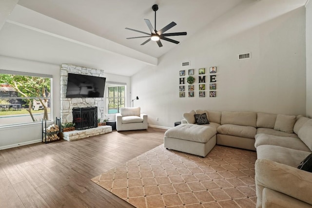 12308 Wycliff Ln, Austin, TX 78727 - living area featuring a ceiling fan, wood finished floors, a stone fireplace, and high vaulted ceiling
