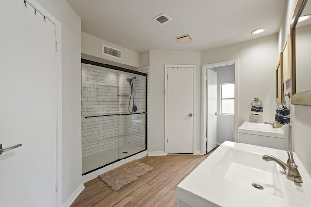 12308 Wycliff Ln, Austin, TX 78727 - bathroom with a shower stall, wood finished floors, and vanity