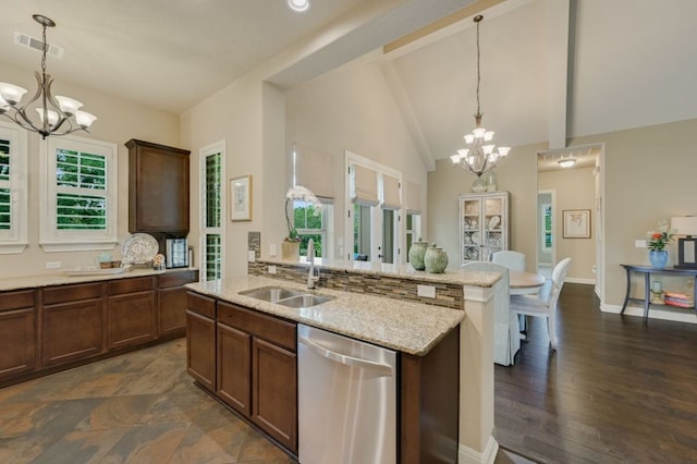 12525 Gray Camlet Ln, Austin, TX 78748 - kitchen featuring a chandelier, dishwasher, a sink, light stone countertops, and pendant lighting