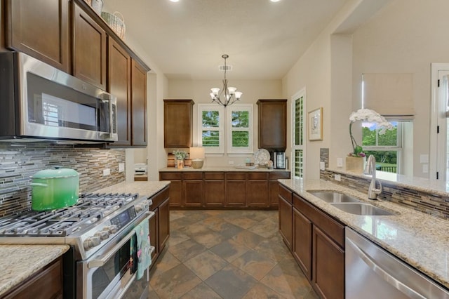 12525 Gray Camlet Ln, Austin, TX 78748 - kitchen with stainless steel appliances, a sink, tasteful backsplash, healthy amount of natural light, and recessed lighting