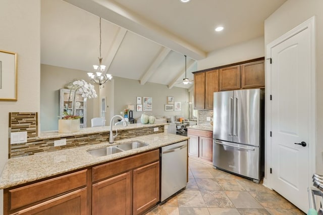 12525 Gray Camlet Ln, Austin, TX 78748 - kitchen with stainless steel appliances, a sink, decorative backsplash, light stone countertops, and brown cabinets