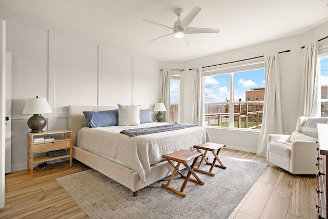 bedroom with multiple windows, light wood-type flooring, and ceiling fan