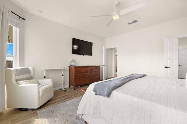 bedroom featuring wood finished floors, ceiling fan, and baseboards