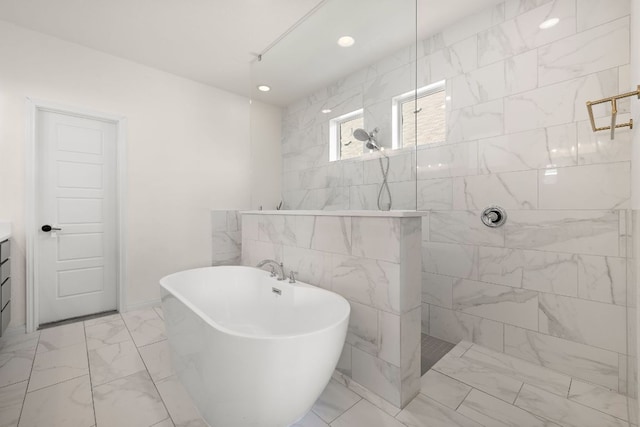 full bath with marble look tile flooring, a walk in shower, a soaking tub, and recessed lighting