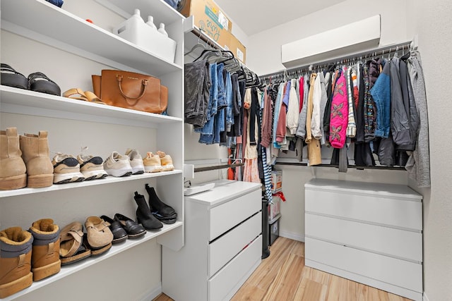 walk in closet with light wood-type flooring