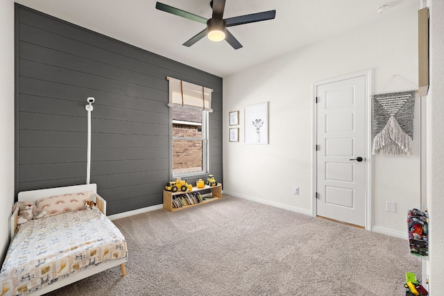 carpeted bedroom with baseboards and a ceiling fan