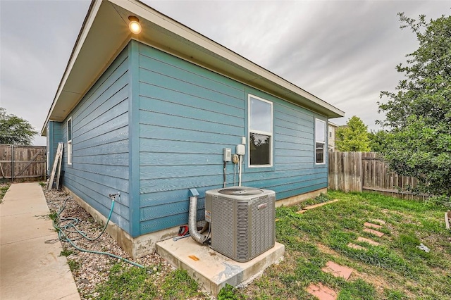 129 Bosque Dr, San Marcos, TX 78666 - view of property exterior featuring fence and central AC