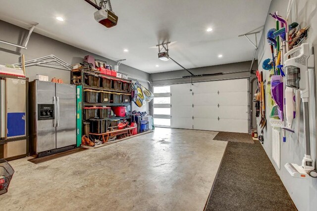 garage with stainless steel fridge with ice dispenser, a garage door opener, and recessed lighting