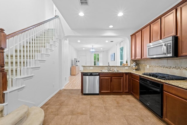 1121 Salem Park Ct, Austin, TX 78745 - kitchen with black appliances, a sink, recessed lighting, decorative backsplash, and a peninsula