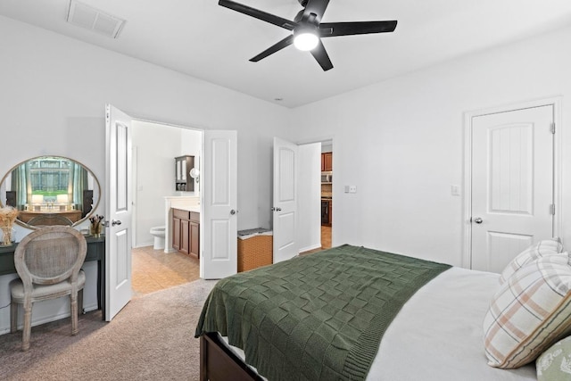 1121 Salem Park Ct, Austin, TX 78745 - bedroom featuring light colored carpet, connected bathroom, and a ceiling fan