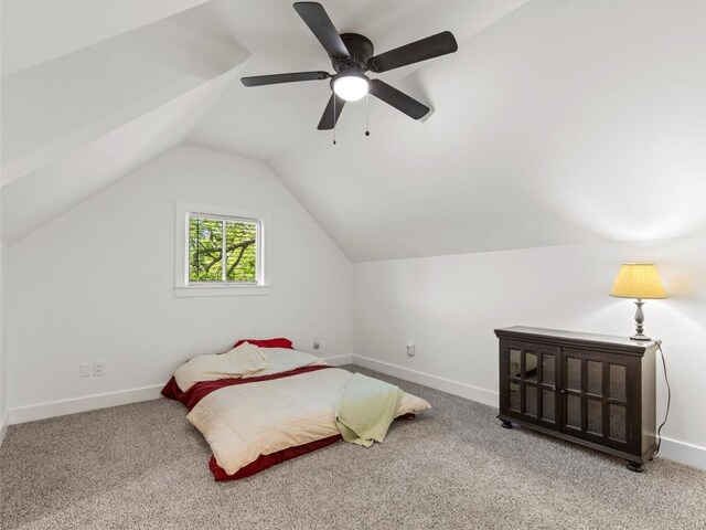 bedroom featuring lofted ceiling, carpet floors, baseboards, and a ceiling fan
