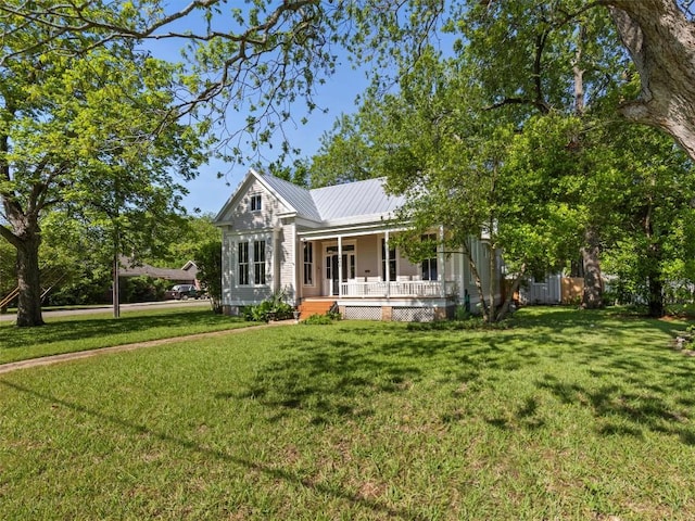 view of front of property with a porch, a front lawn, and metal roof