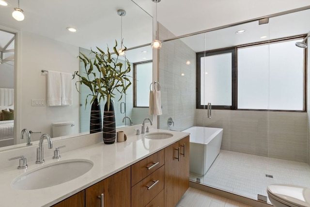 607 Terrell Hill Dr Unit B, Austin, TX 78704 - bathroom featuring toilet, a freestanding tub, double vanity, and tile patterned flooring