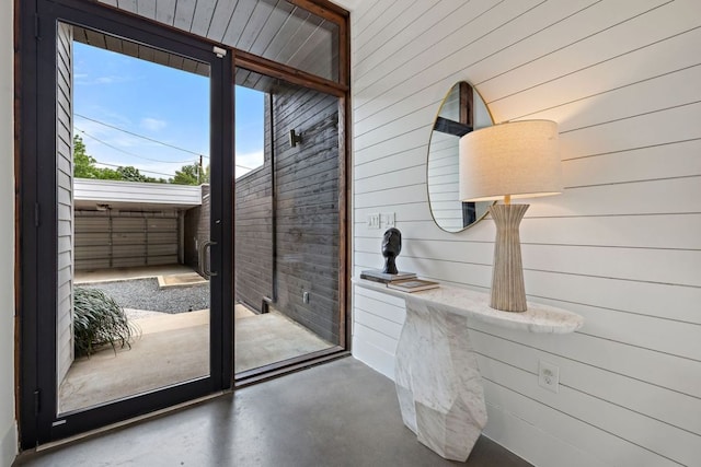 607 Terrell Hill Dr Unit B, Austin, TX 78704 - doorway featuring wooden walls and finished concrete flooring