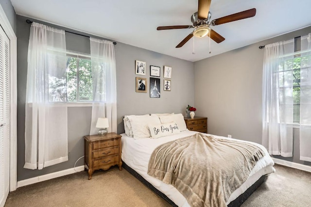 906 Hermitage Dr, Austin, TX 78753 - bedroom featuring light carpet, multiple windows, a ceiling fan, and a closet