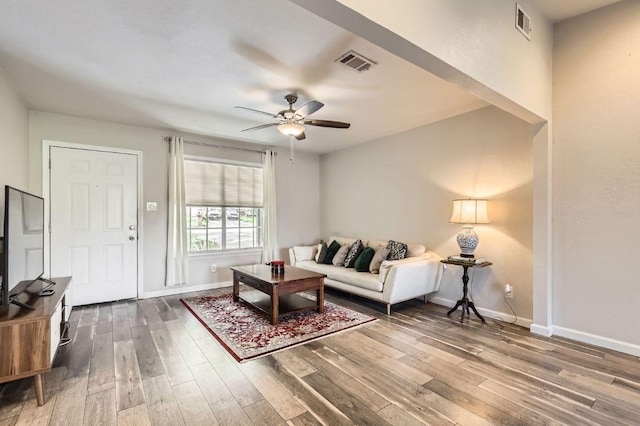 906 Hermitage Dr, Austin, TX 78753 - living area featuring a ceiling fan, wood finished floors, and baseboards