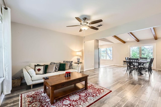 906 Hermitage Dr, Austin, TX 78753 - living area featuring a ceiling fan, light wood-type flooring, beamed ceiling, and baseboards