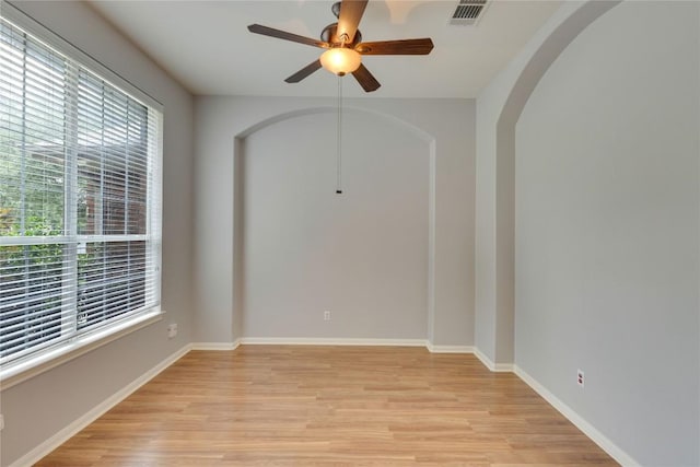 1012 Klondike Loop, Round Rock, TX 78665 - empty room featuring light wood-style floors, ceiling fan, and arched walkways