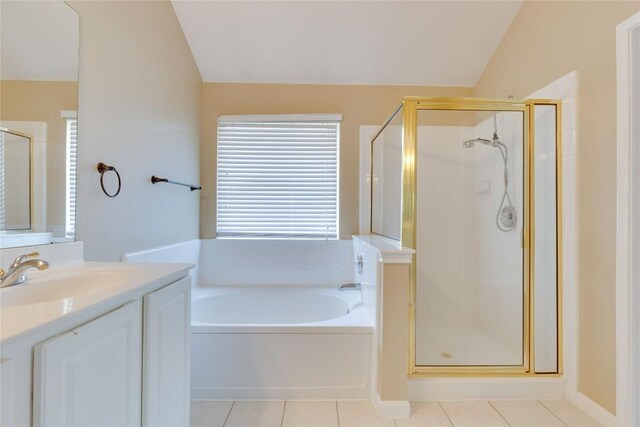 1012 Klondike Loop, Round Rock, TX 78665 - full bathroom featuring vaulted ceiling, a shower stall, a garden tub, and tile patterned flooring