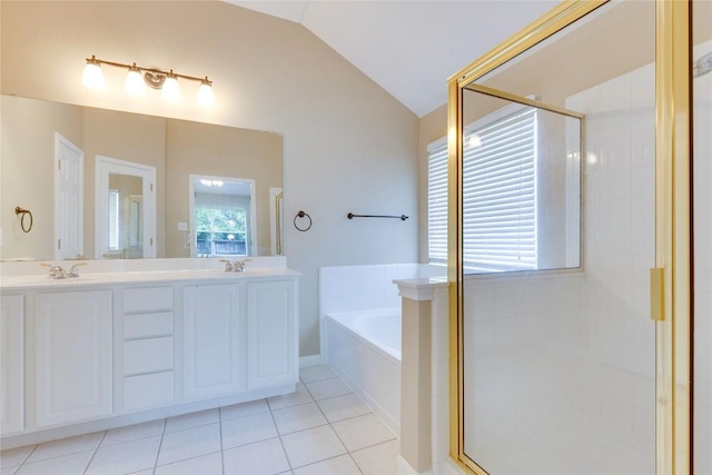 1012 Klondike Loop, Round Rock, TX 78665 - bathroom featuring vaulted ceiling, a garden tub, double vanity, tile patterned flooring, and a shower stall