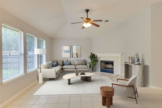 1012 Klondike Loop, Round Rock, TX 78665 - living area featuring plenty of natural light, vaulted ceiling, a tiled fireplace, light tile patterned flooring, and a ceiling fan