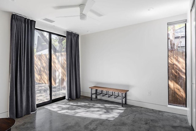 spare room with concrete flooring and ceiling fan