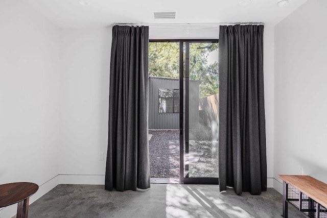 unfurnished room with concrete flooring