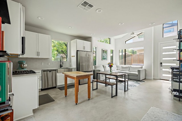 1405 Perez St Unit 2, Austin, TX 78721 - kitchen with stainless steel appliances, light countertops, recessed lighting, white cabinetry, and backsplash