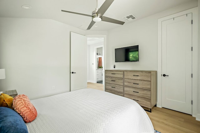 bedroom with light wood-type flooring, a ceiling fan, and lofted ceiling