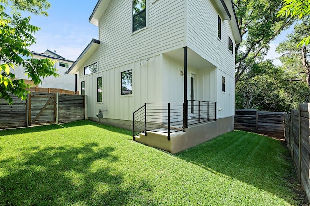 1405 Perez St Unit 2, Austin, TX 78721 - rear view of house with board and batten siding and a fenced backyard