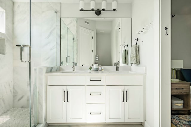 bathroom with a stall shower and double vanity