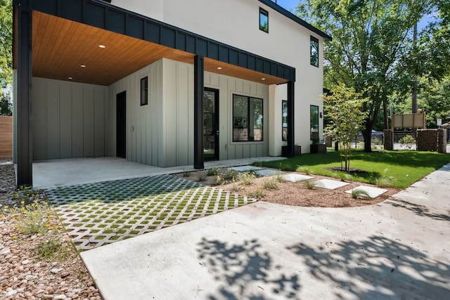 517 Tillery St Unit 1, Austin, TX 78702 - view of exterior entry with a patio and board and batten siding