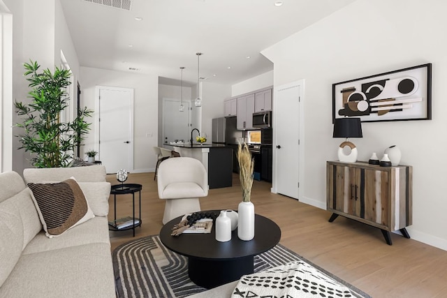 517 Tillery St Unit 1, Austin, TX 78702 - living area with light wood-style floors and recessed lighting