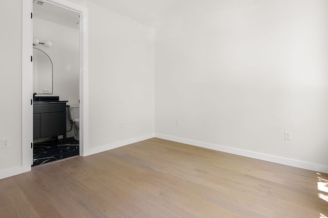 517 Tillery St Unit 1, Austin, TX 78702 - unfurnished bedroom featuring wood finished floors and ensuite bath