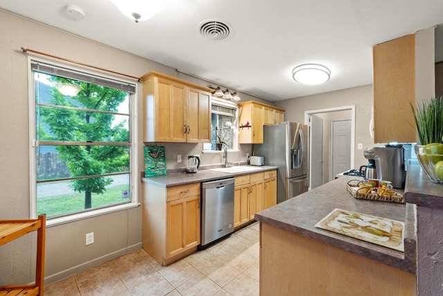 8017 Gault St, Austin, TX 78757 - kitchen with appliances with stainless steel finishes, plenty of natural light, and light brown cabinetry