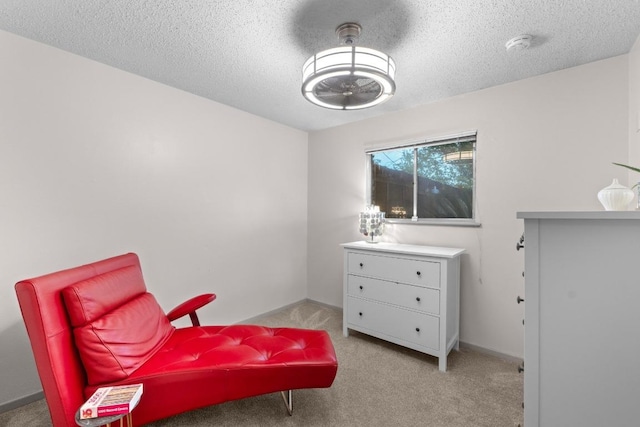 8017 Gault St, Austin, TX 78757 - sitting room featuring carpet flooring, a textured ceiling, and baseboards
