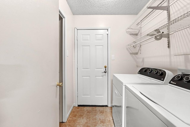 8017 Gault St, Austin, TX 78757 - laundry room with washer and dryer, light tile patterned floors, a textured ceiling, and baseboards
