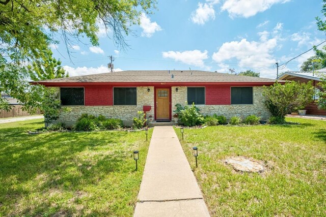 8017 Gault St, Austin, TX 78757 - ranch-style home featuring stone siding, a front yard, and a shingled roof