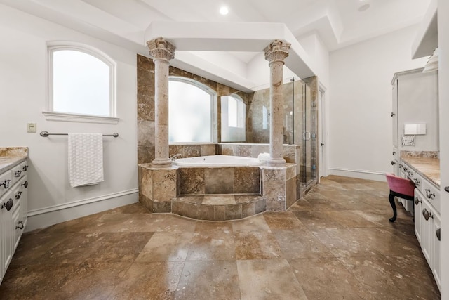 bathroom featuring vanity, a bath, stone tile flooring, and a stall shower