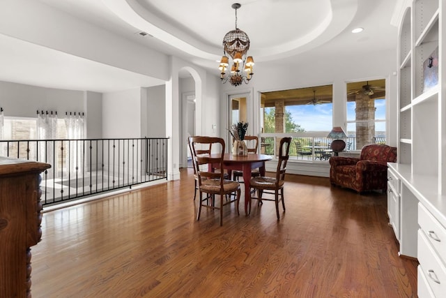 401 Brooks Hollow Rd, Lakeway, TX 78734 - dining space featuring dark wood finished floors, a chandelier, a ceiling fan, arched walkways, and recessed lighting