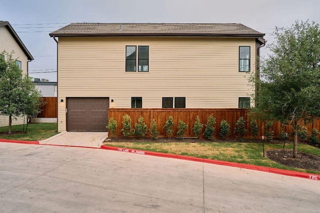 2209 Woodland Ave Unit 101, Austin, TX 78741 - view of side of property featuring a garage and concrete driveway