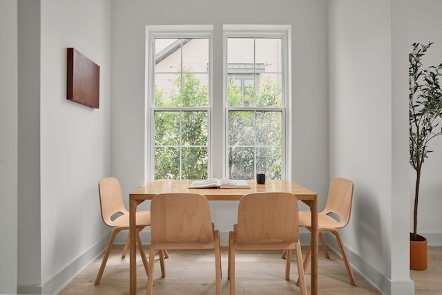 2209 Woodland Ave Unit 101, Austin, TX 78741 - dining room with baseboards and light wood-style flooring