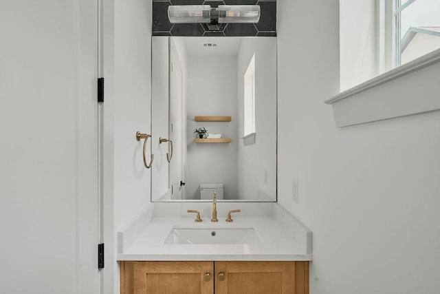 2209 Woodland Ave Unit 101, Austin, TX 78741 - bathroom featuring toilet, plenty of natural light, and vanity