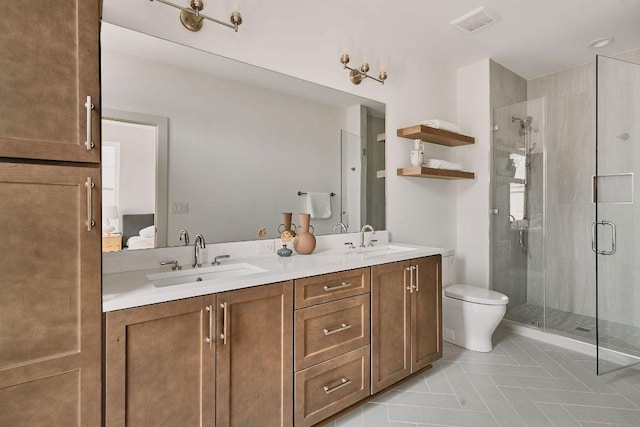 2209 Woodland Ave Unit 101, Austin, TX 78741 - bathroom with a stall shower, double vanity, toilet, and tile patterned flooring