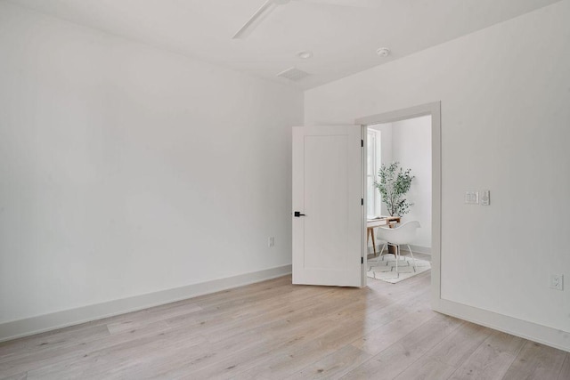 2209 Woodland Ave Unit 101, Austin, TX 78741 - unfurnished room with light wood-type flooring, baseboards, and a desk