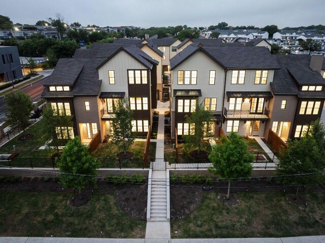 2209 Woodland Ave Unit 101, Austin, TX 78741 - back of house featuring a balcony, a residential view, and board and batten siding